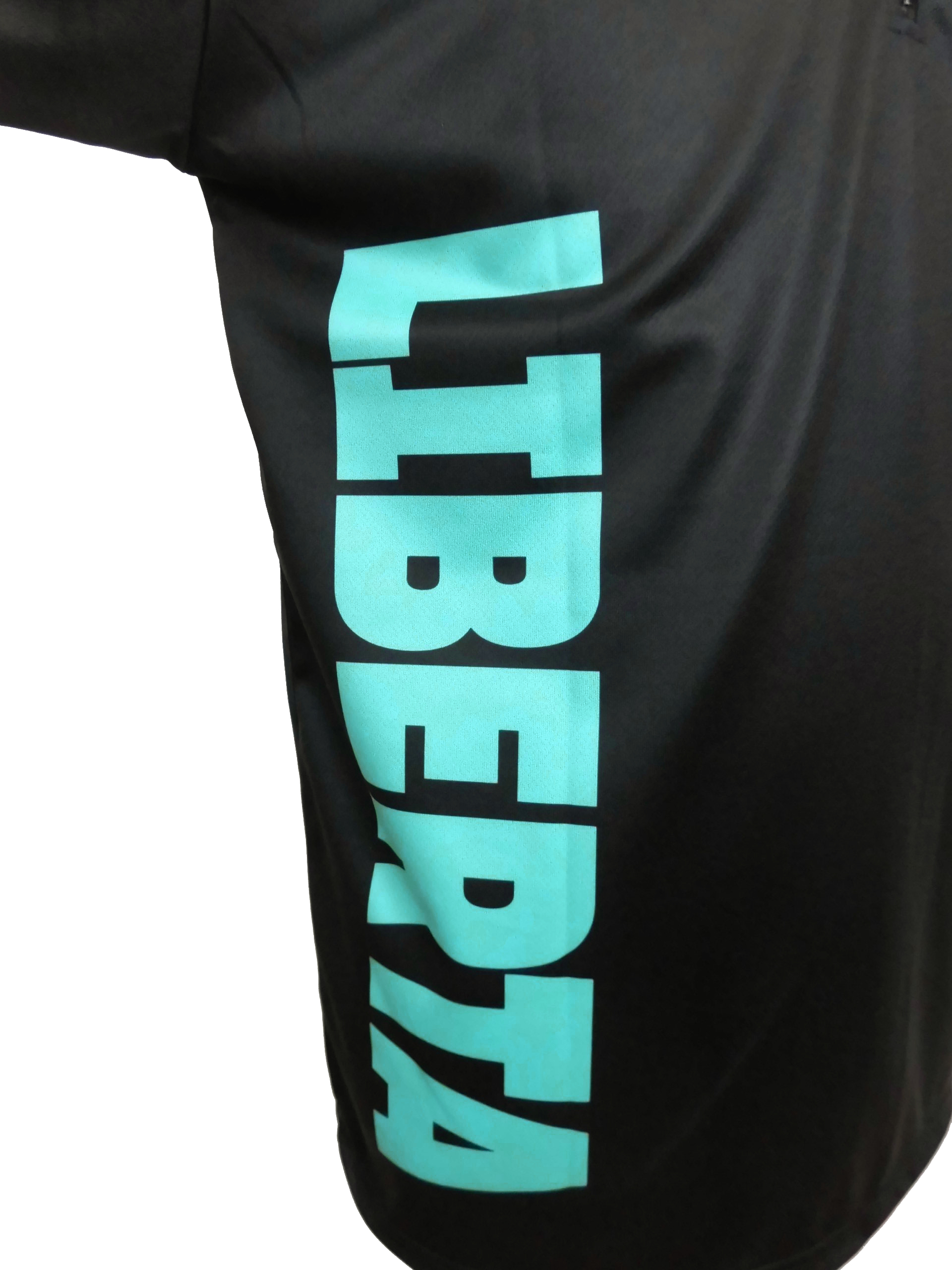 Close-up of a black T-shirt with large turquoise vertical text partially visible.