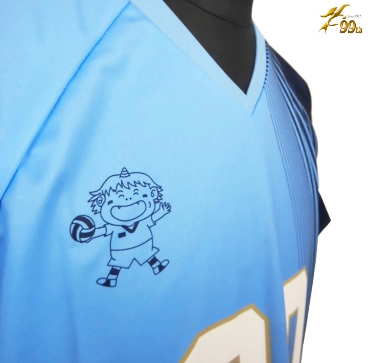 Light blue sports jersey with a cartoon boy mascot holding a volleyball on the left chest area.