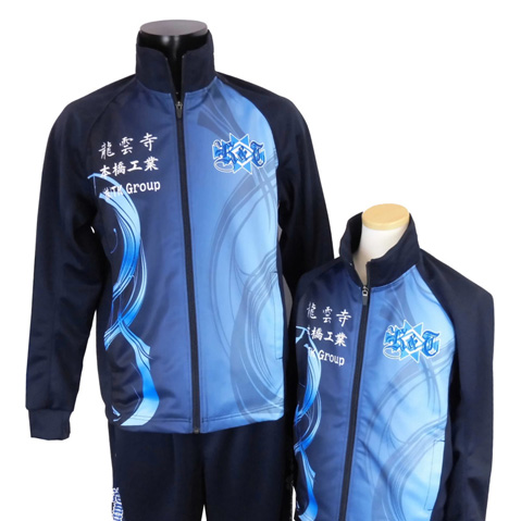Two blue zip-up tracksuits on display, featuring light-blue swirl patterns and a club crest.