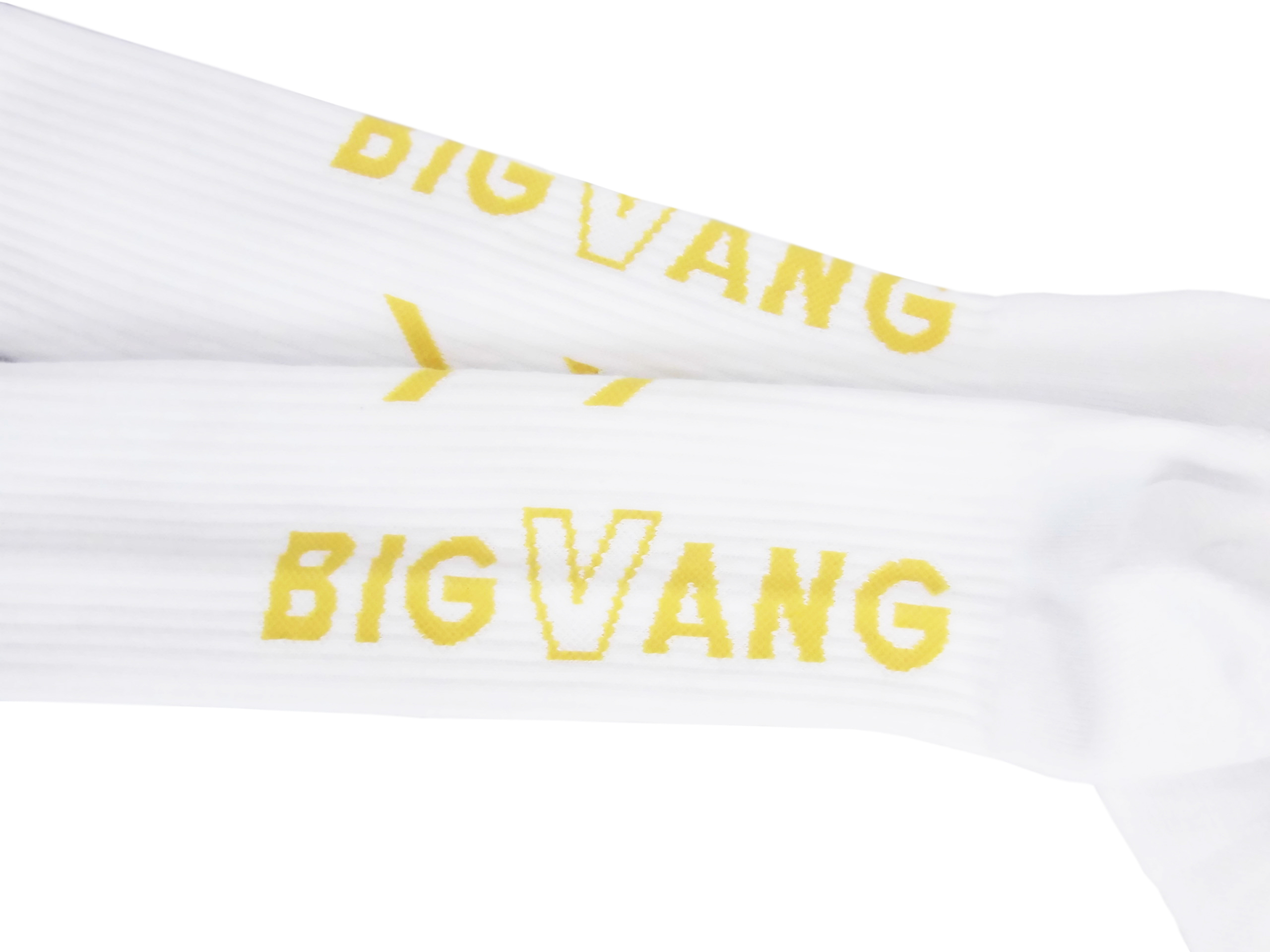 White fabric or paper with yellow printed text 'BIGVANG' shown diagonally across the surface.
