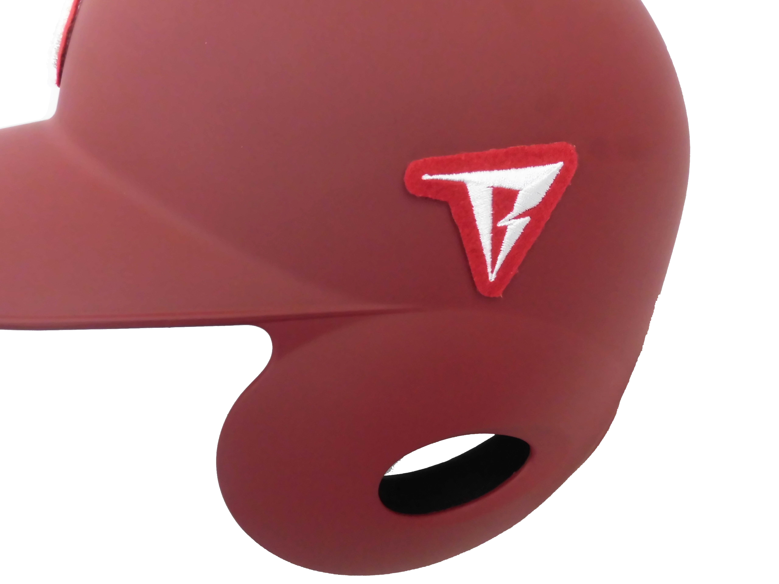 Close-up of red fabric with a small red-bordered white lightning-bolt patch.