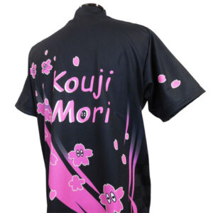 Back view of a black sports jersey with pink cherry blossom graphics and the name 'Kouji Mori' across the back.