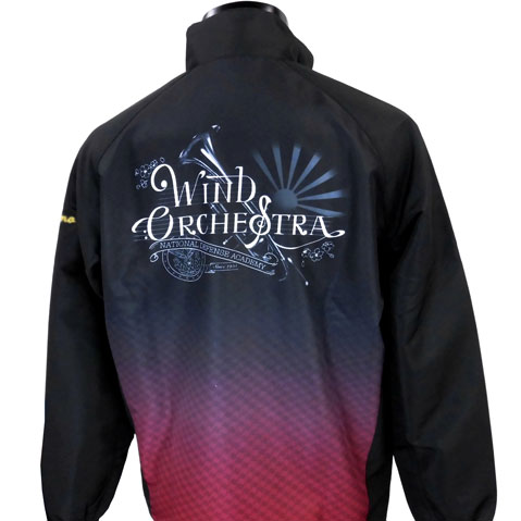 Back view of a black wind orchestra jacket featuring a gradient red-to-pink bottom and white decorative logo reading 'Wind Orchestra' with a sunburst design above.